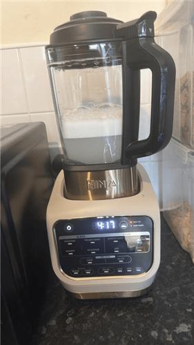 Ninja Foodi Blender and Soup Maker mid-blend on a kitchen counter